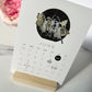 2027 MYSTIC MAMMA MOON calendar June card on stand featuring collage of women dancing with butterfly wings