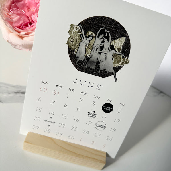 2027 MYSTIC MAMMA MOON calendar June card on stand featuring collage of women dancing with butterfly wings